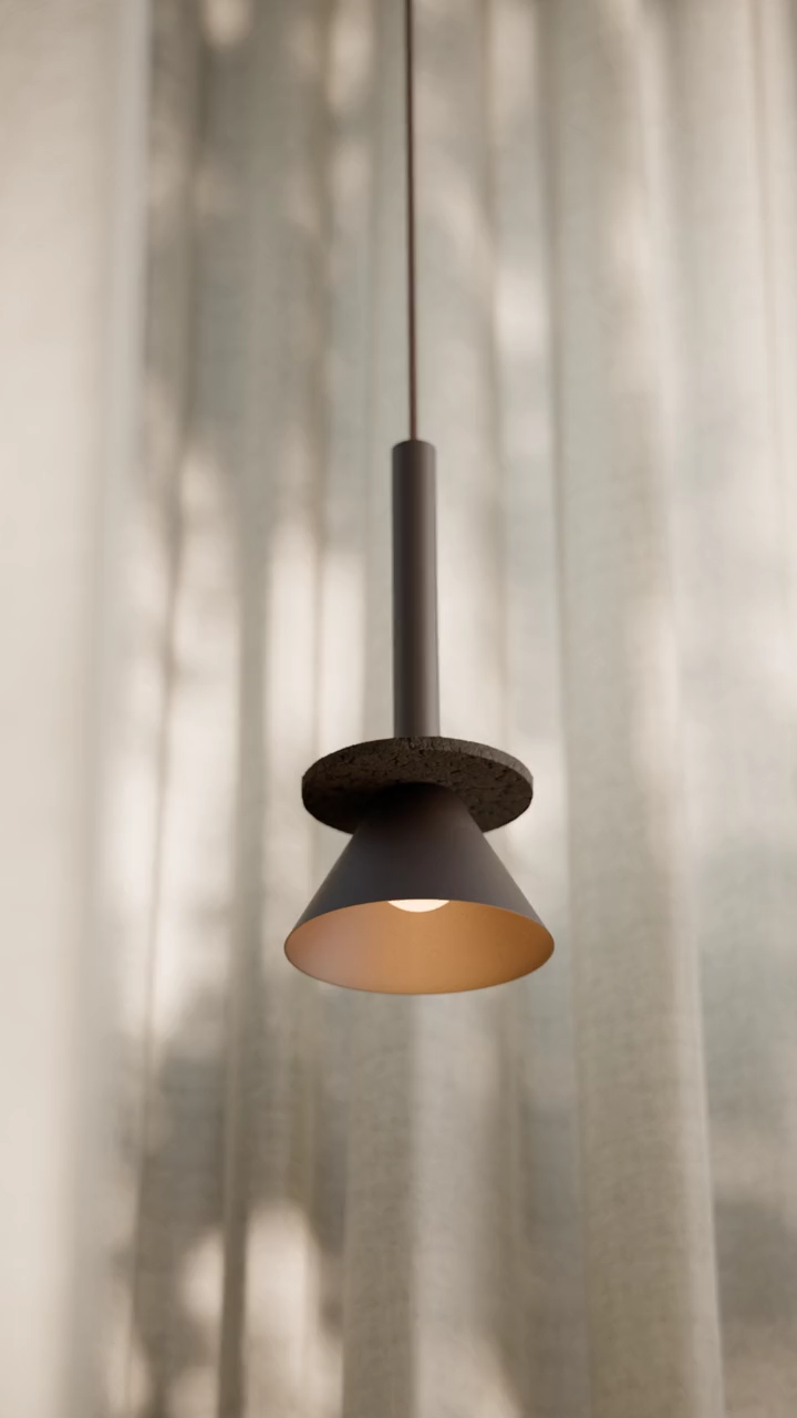 A Figure pendant with a cork disc in a warm cafe