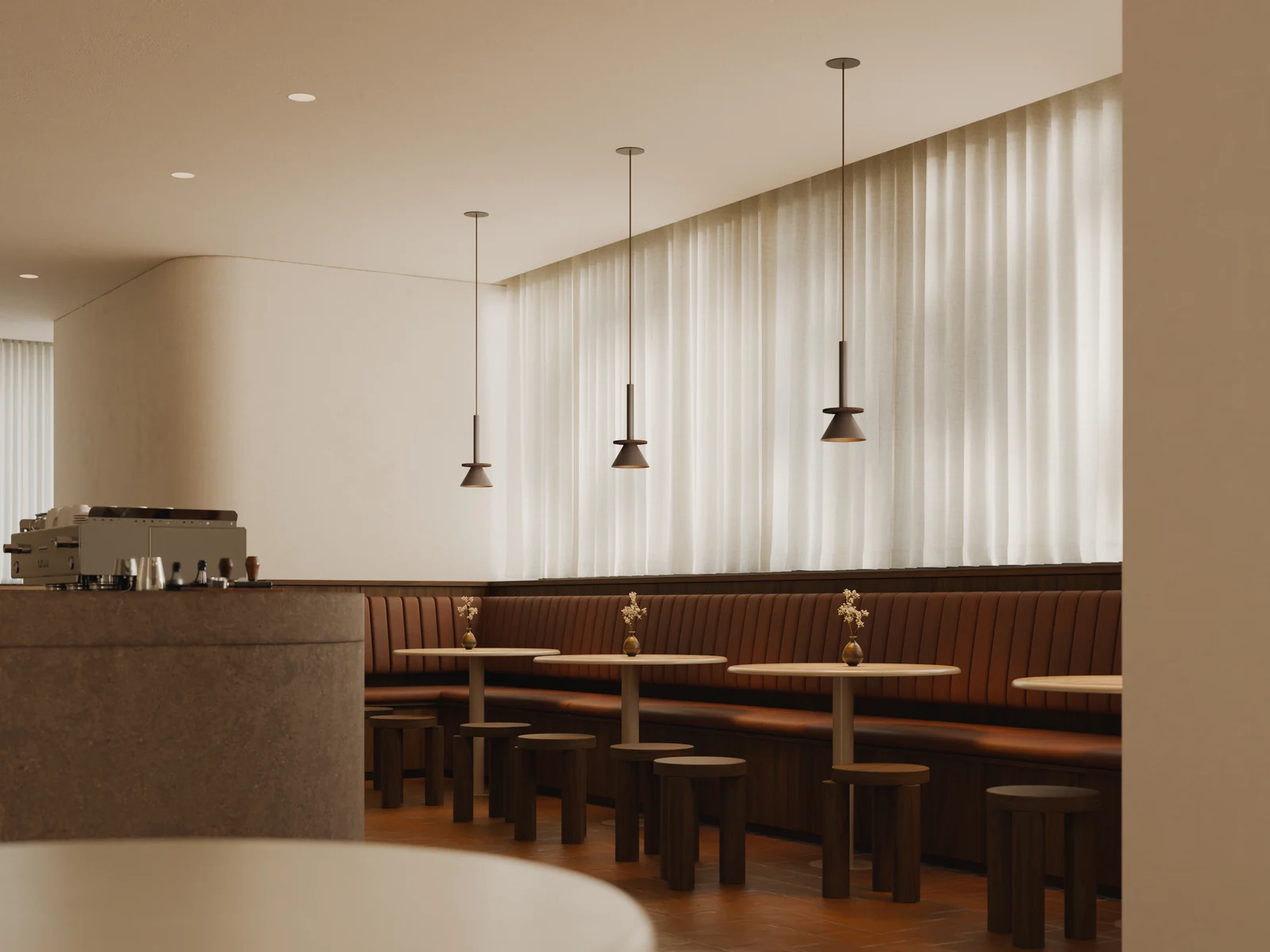 Figure pendants above the seating in a warm cafe